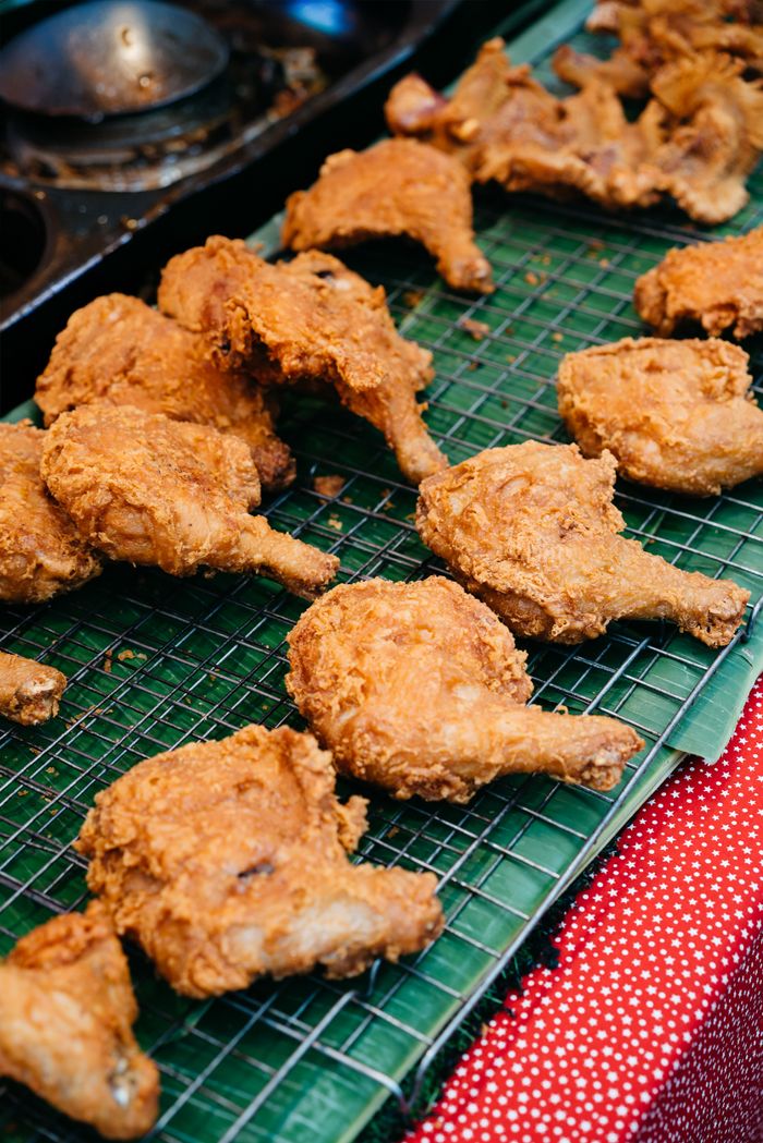 Delicious crispy fried chicken displayed at a street market stall, perfect for a tasty meal.